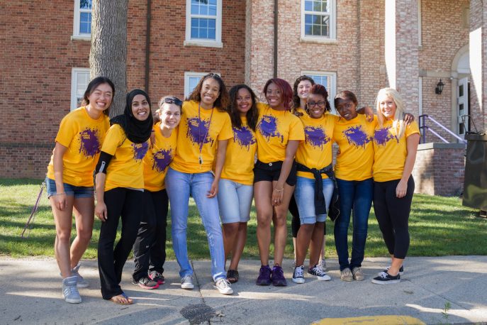 Group of students posing outside on campus.