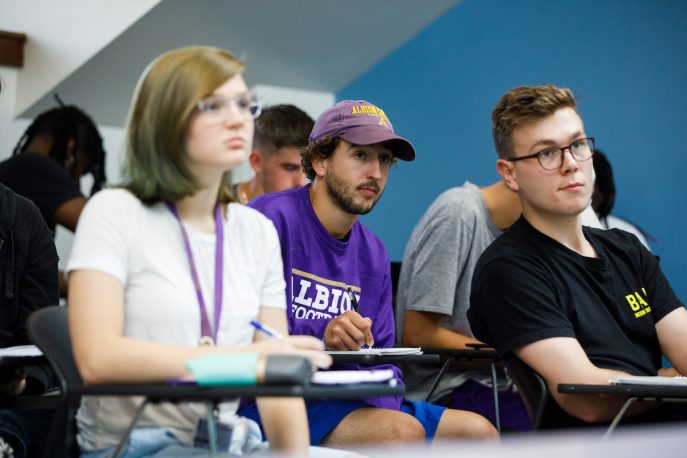 Albion students listening to a lecture in a classroom setting.