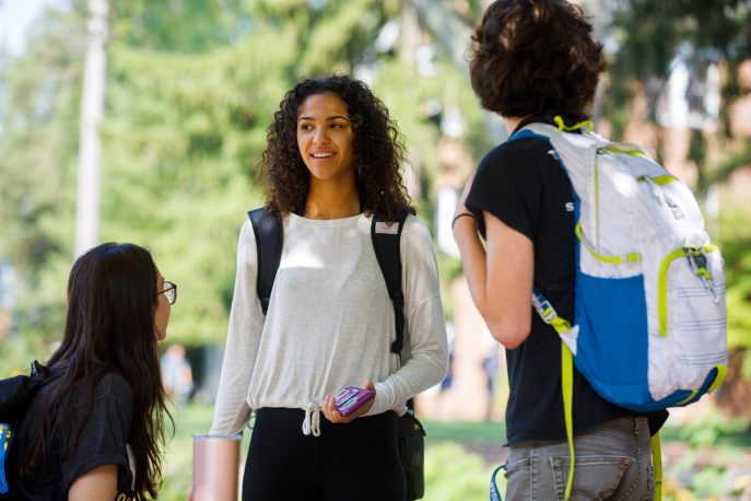 Students outside conversing on campus.