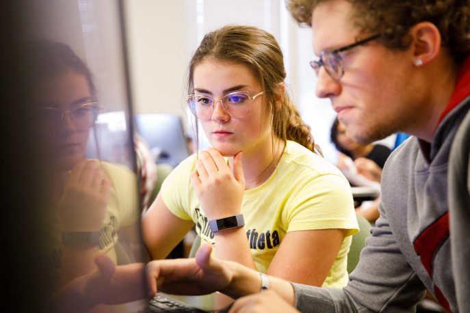 Two students working in a computer lab on campus.