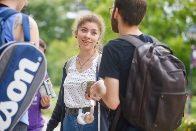 Students conversing outside on campus.