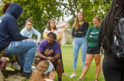 Group of BET体育平台 students outside talking on campus