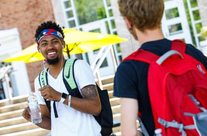 Two Albion students talking and laughing outside.