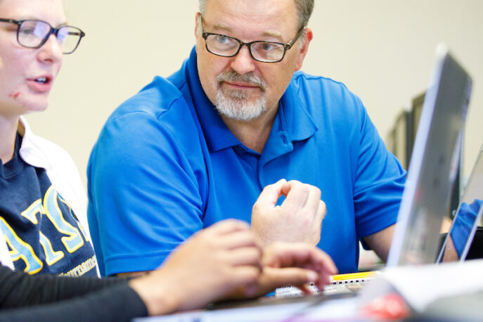 Students and a professor in the computer lab.