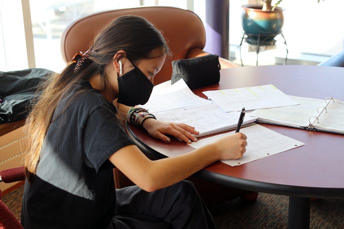 Albion College student working at a table