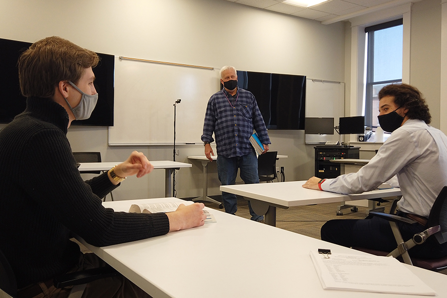 Dr. John Carlson (center background) with two Albion College accounting students