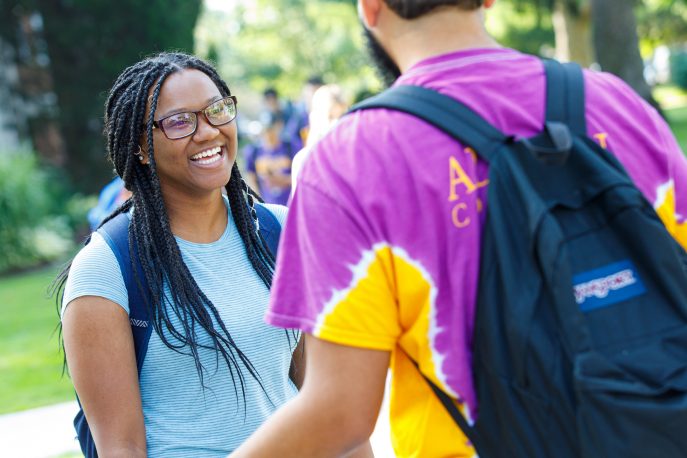 Two students in conversation on the Quad.