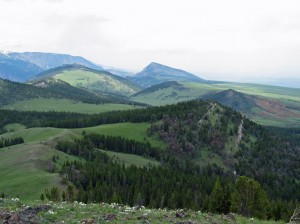 View of hills with mountains in the background.