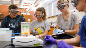 Four students in a science lab.