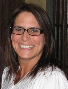 A photo of a woman's face, smiling.