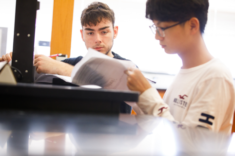 Students working together at a desk.