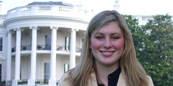 A headshot of a student standing in front of a building.
