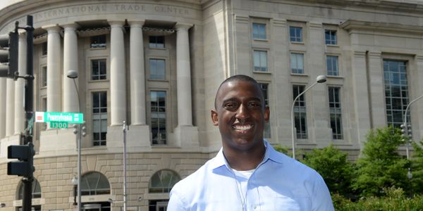 A student standing in front of a building.