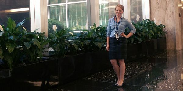 A student standing in front of a building.