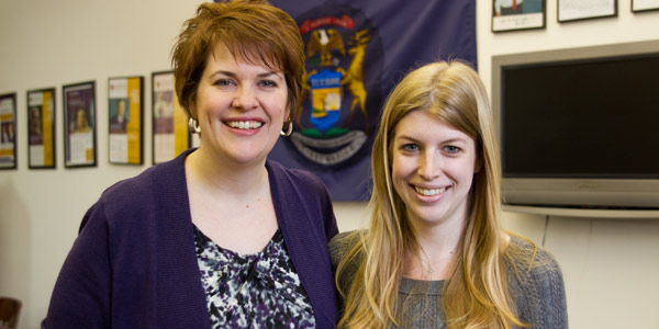A headshot of two people smiling at the camera.