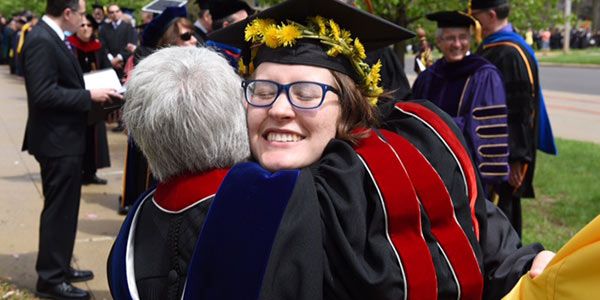 A student hugging someone.