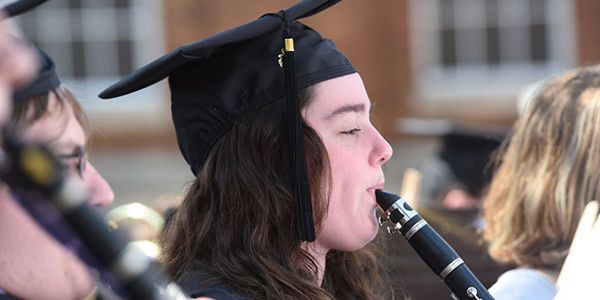A musician blowing into an instrument.