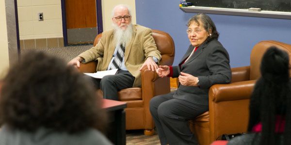 Two people sitting in armchairs.