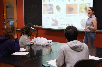 Dr. Abigail Cahill addresses students in a biology lecture.
