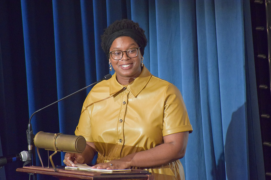A woman speaking behind a podium.