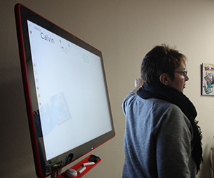 A professor standing in front of a jamboard.