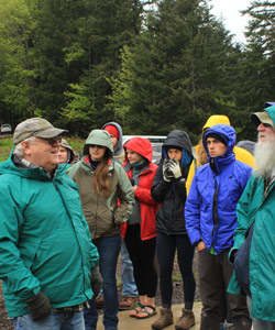 A group of students outside wearing coats.