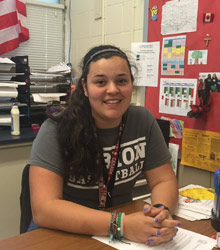 Victoria Della Pia sitting at at table.