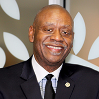 A headshot of a man wearing a suit.