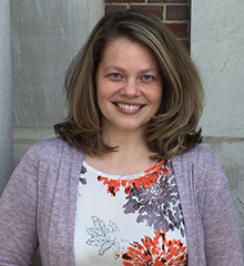 A professor posing in a floral shirt.