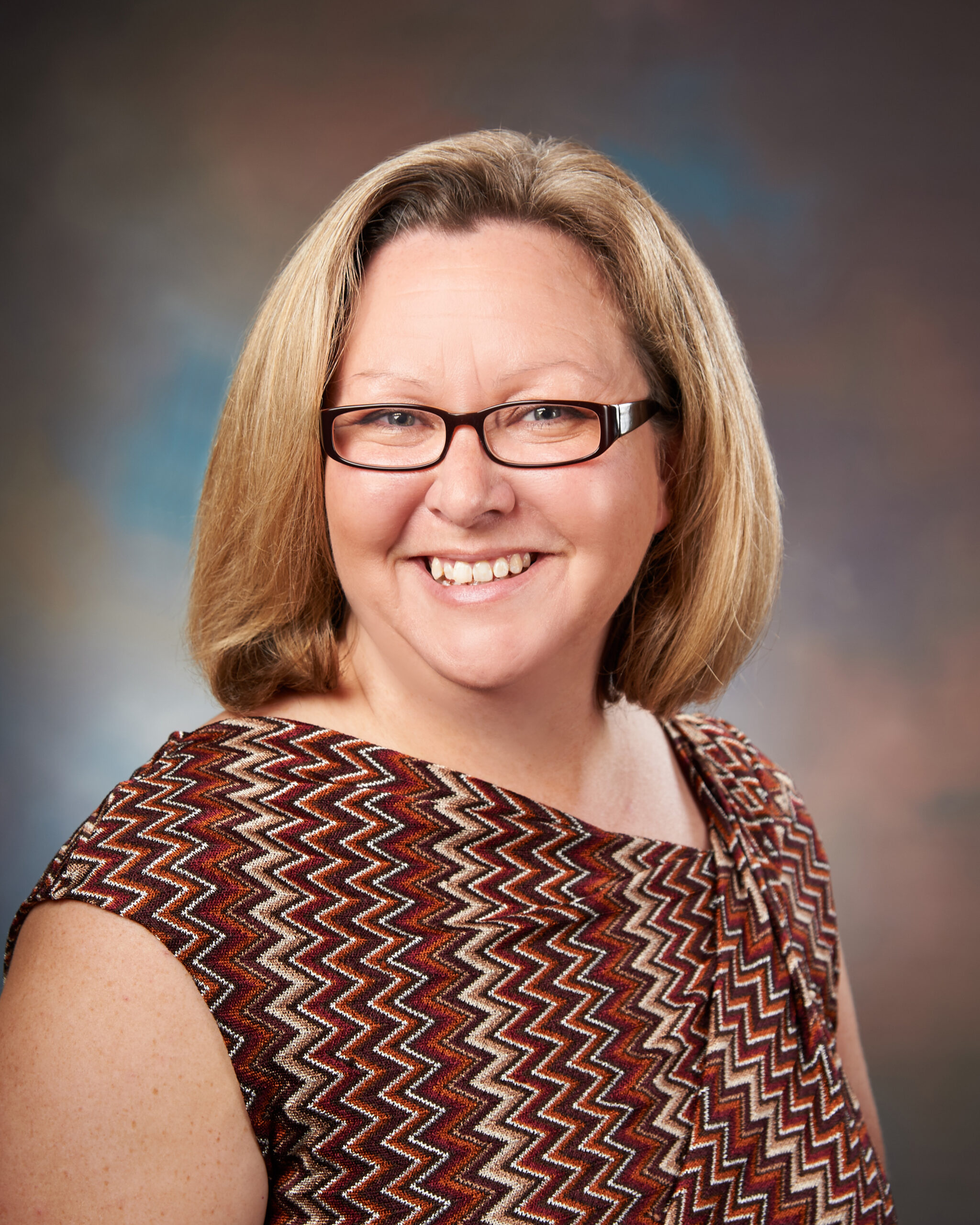 A professional headshot of Elisa Reynolds.