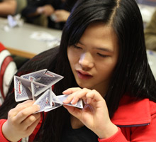 Student handling math sculpture.