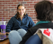 two student facing teach other while talking