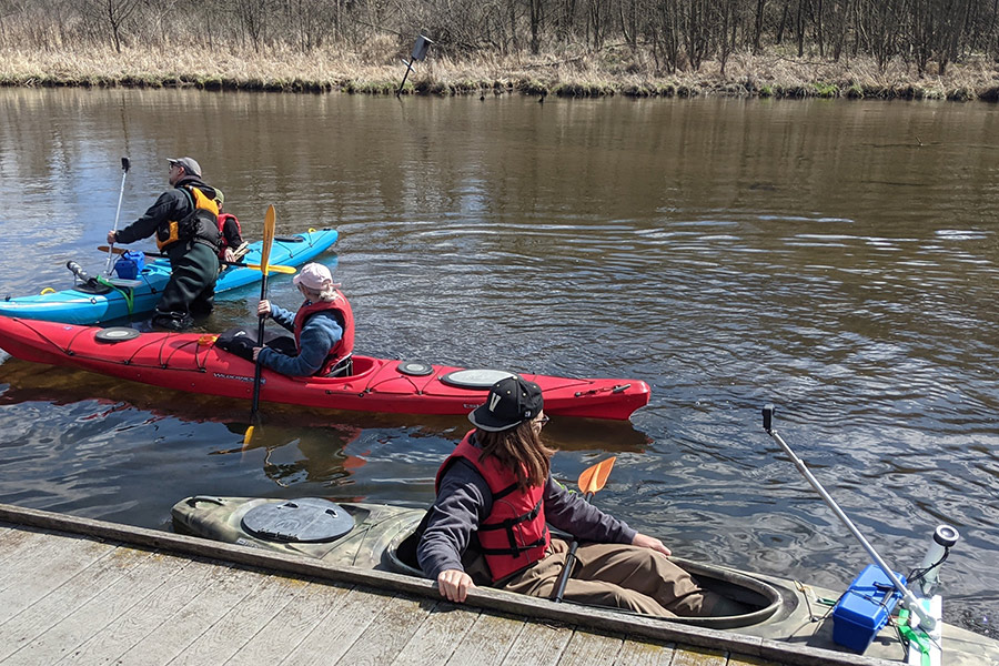 People in canoes on a river.