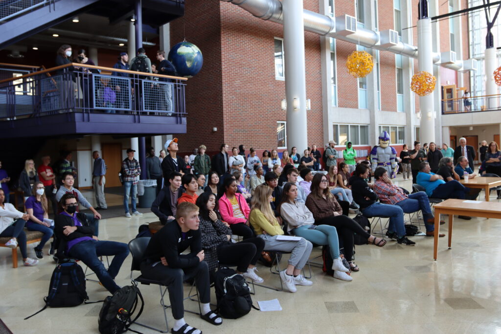 A large group of students watch the launch from the Science Atrium. 