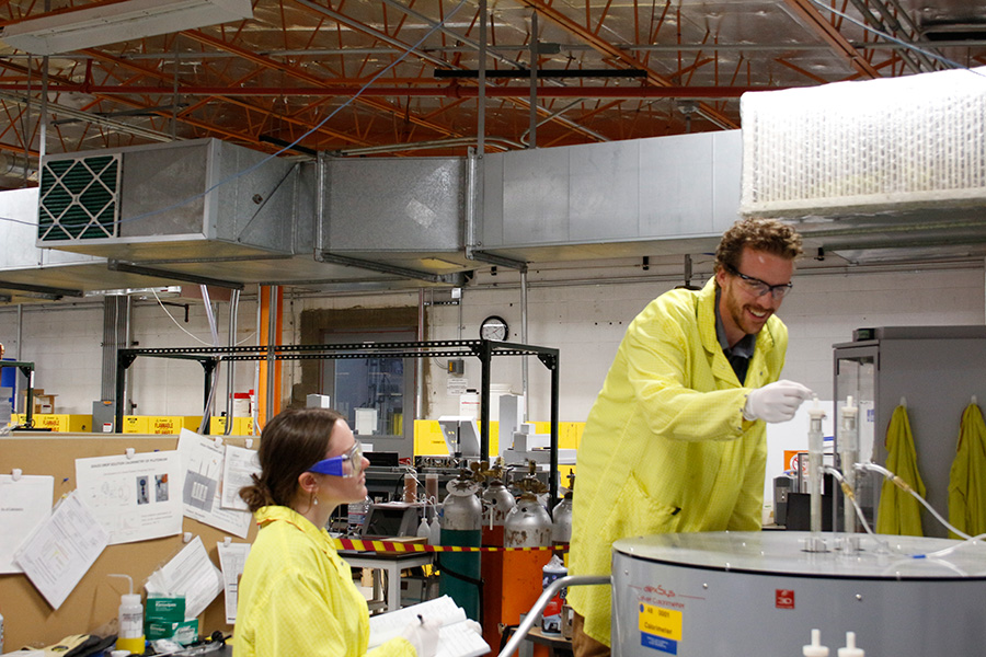 Paige McDowell watches Dr. Strzelecki work in the lab.