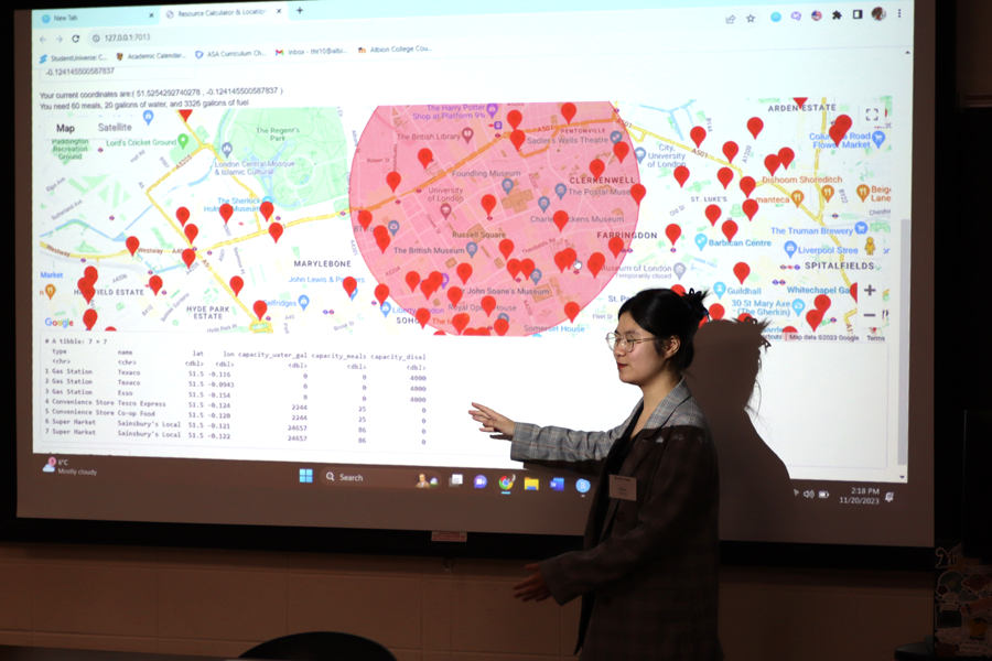 Chloe points to the screen, which shows a map with points on it.